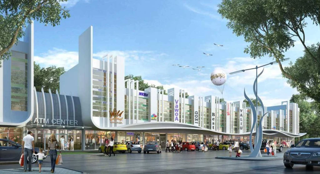 Tampilan depan deretan ruko Belleza Plaza di CitraLand Cirebon. Bangunan modern dengan dua dan tiga lantai, area pejalan kaki ramai, dan area parkir yang luas, menunjukkan suasana komersial yang hidup.